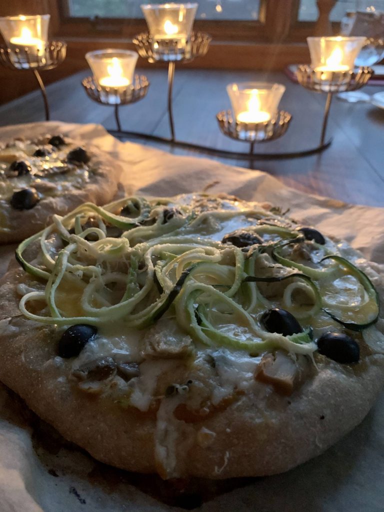 Homemade pizzas with spiralized zucchini and fresh basil