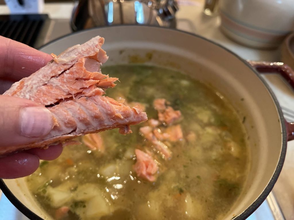 adding salmon to chowder