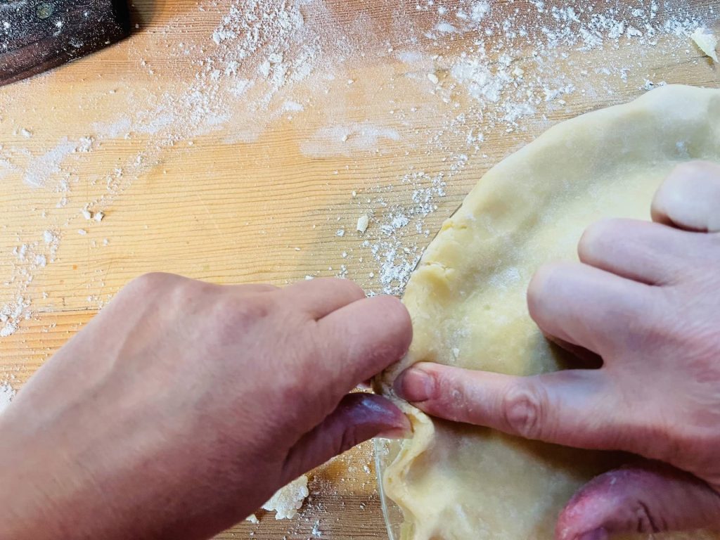 Fold top crust under bottom crust, seal, and crimp