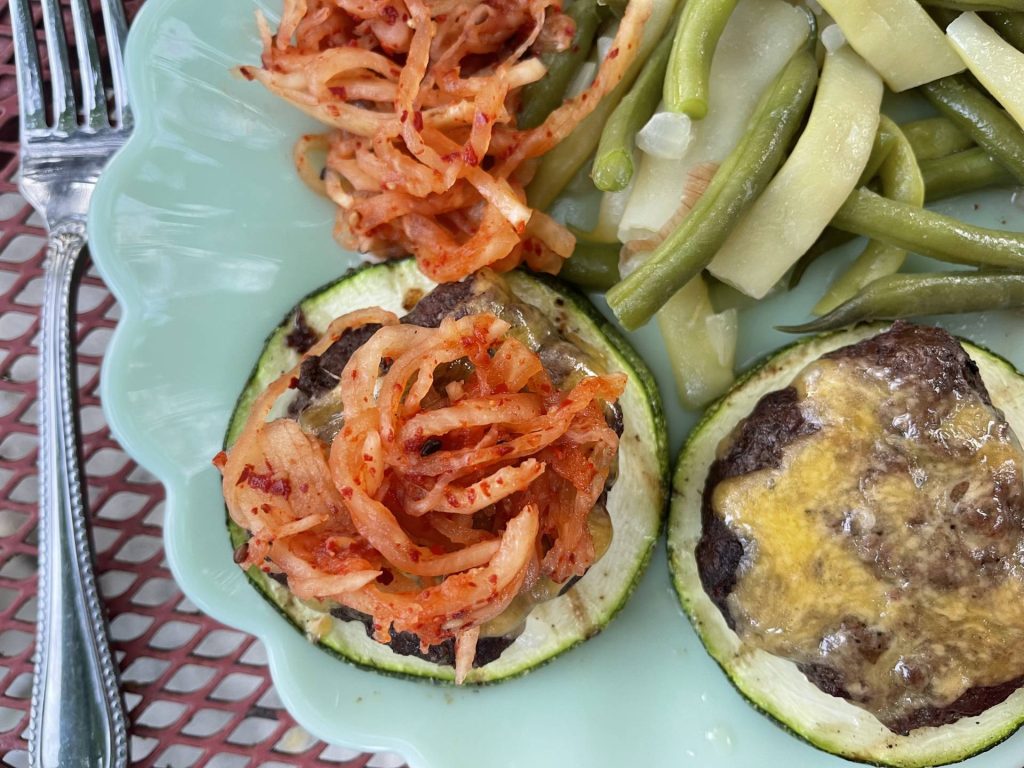 Grilled burgers on grilled zucchini slice buns