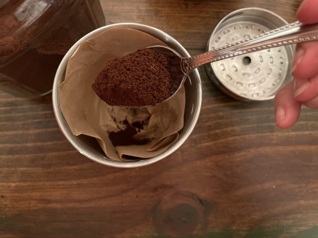 adding coffee grounds to basket