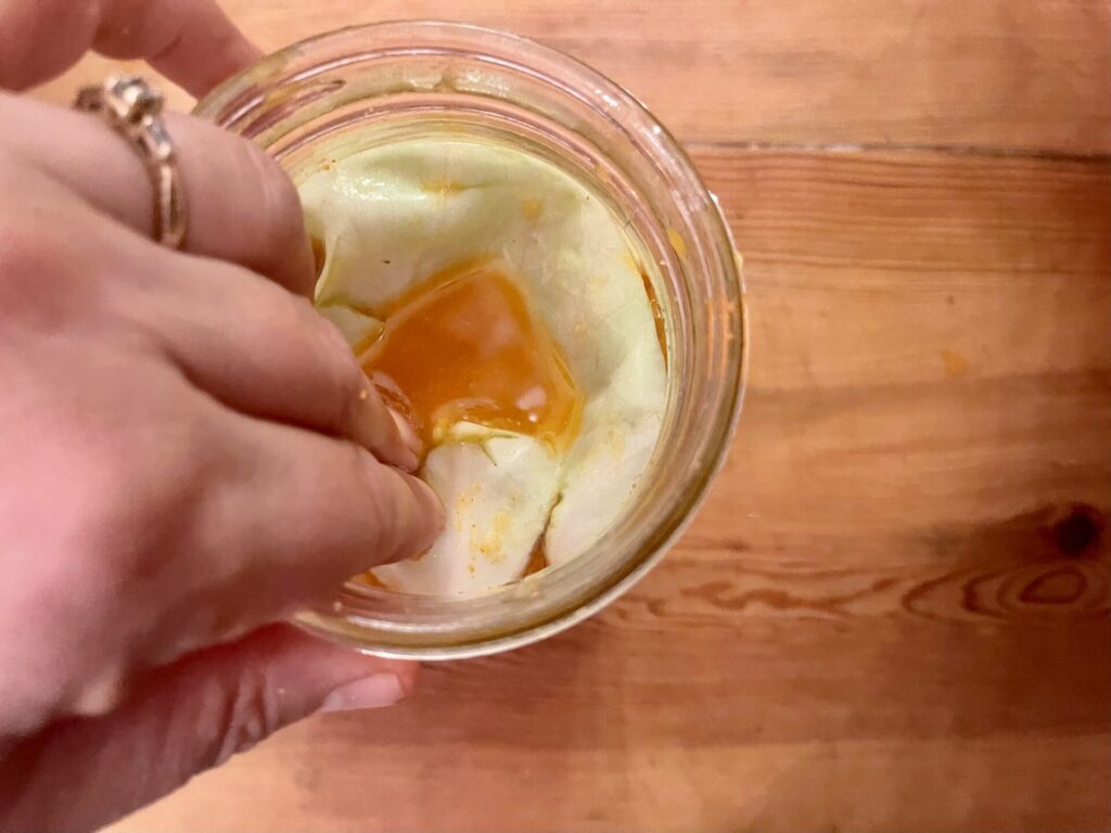 Add folded cabbage leaf