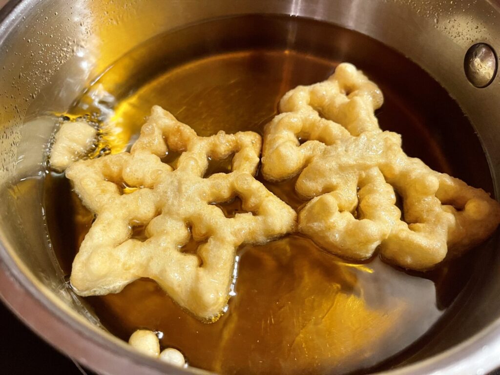 Rosettes frying in avocado oil